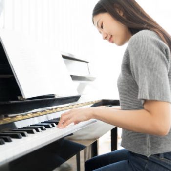 Portrait Asian woman playing  playing piano